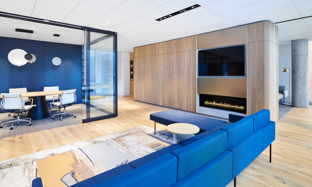 Modern office area with blue seating and birch wood panelling.