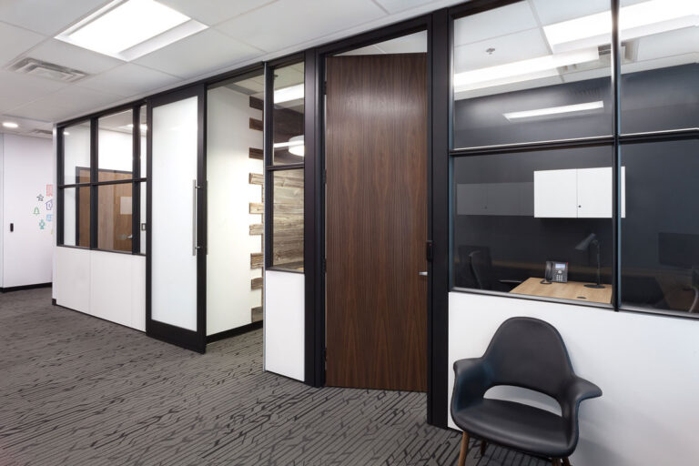Exterior view of executive offices with black cladding dark stained door.