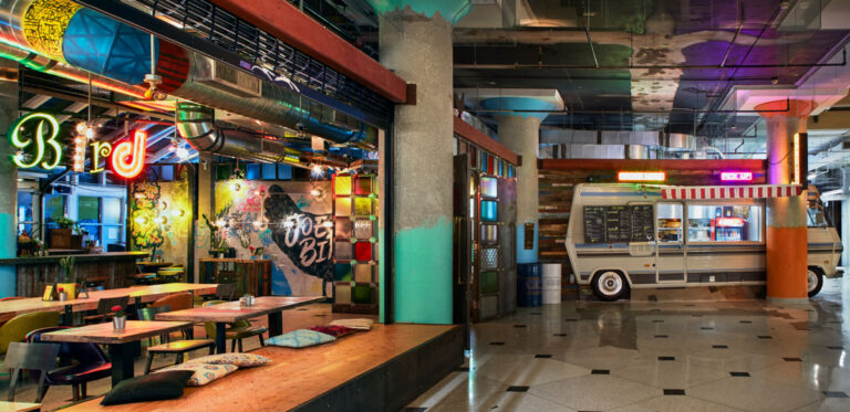 Ecclectic restaurant design with textured and coloured elements.