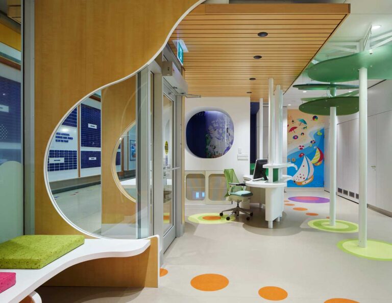Reception desk and entry at SickKids PlayPark with coloured circles in random organic patterns.