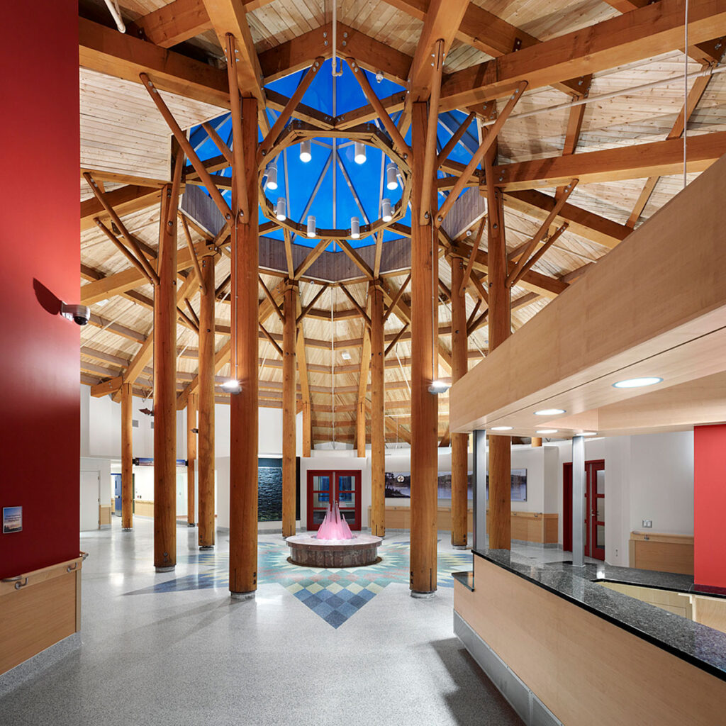 Tall timber columns and beams welcome everyone into the health centre with a large octagonal skylight at the centre.