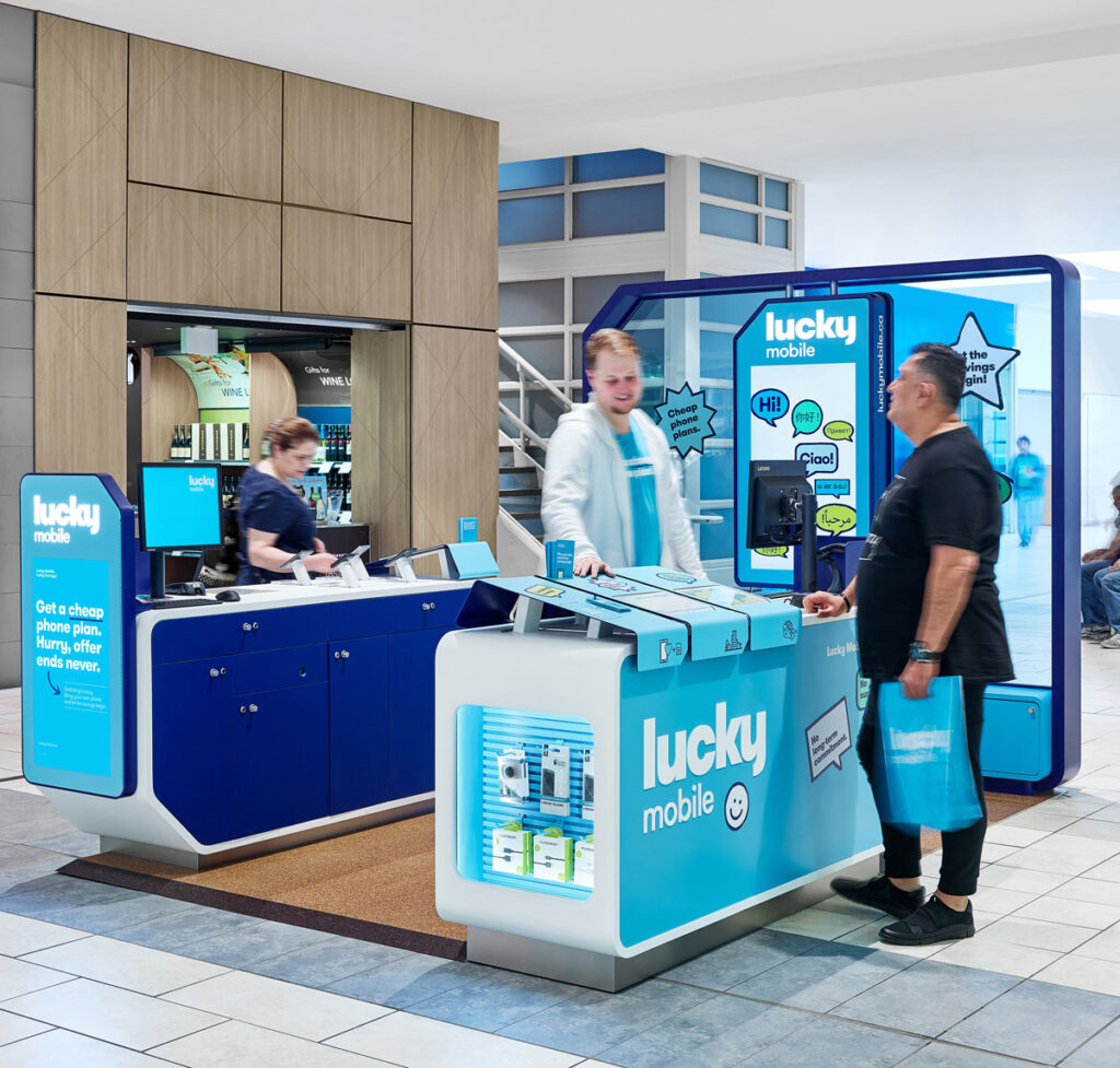 Patrons interact with staff at Lucky Mobile kiosk