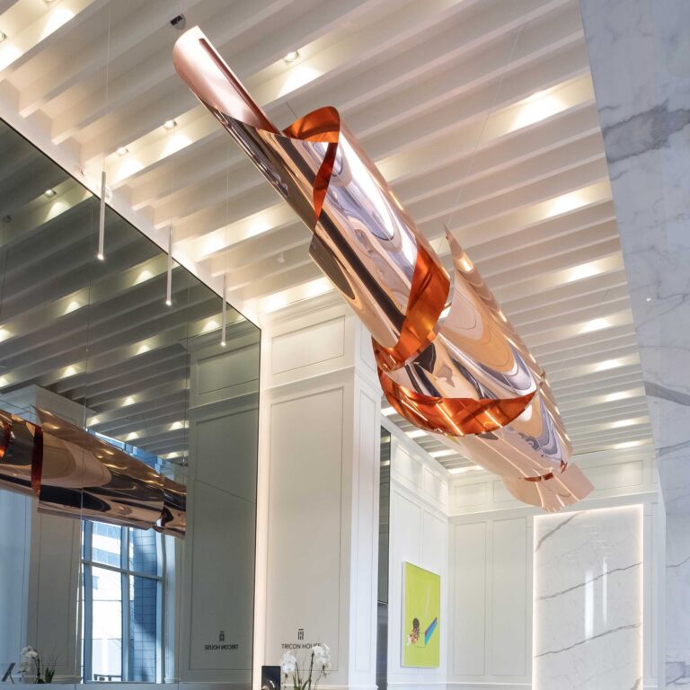 A twisting copper sculpture is suspended in the lobby of a Toronto condo.