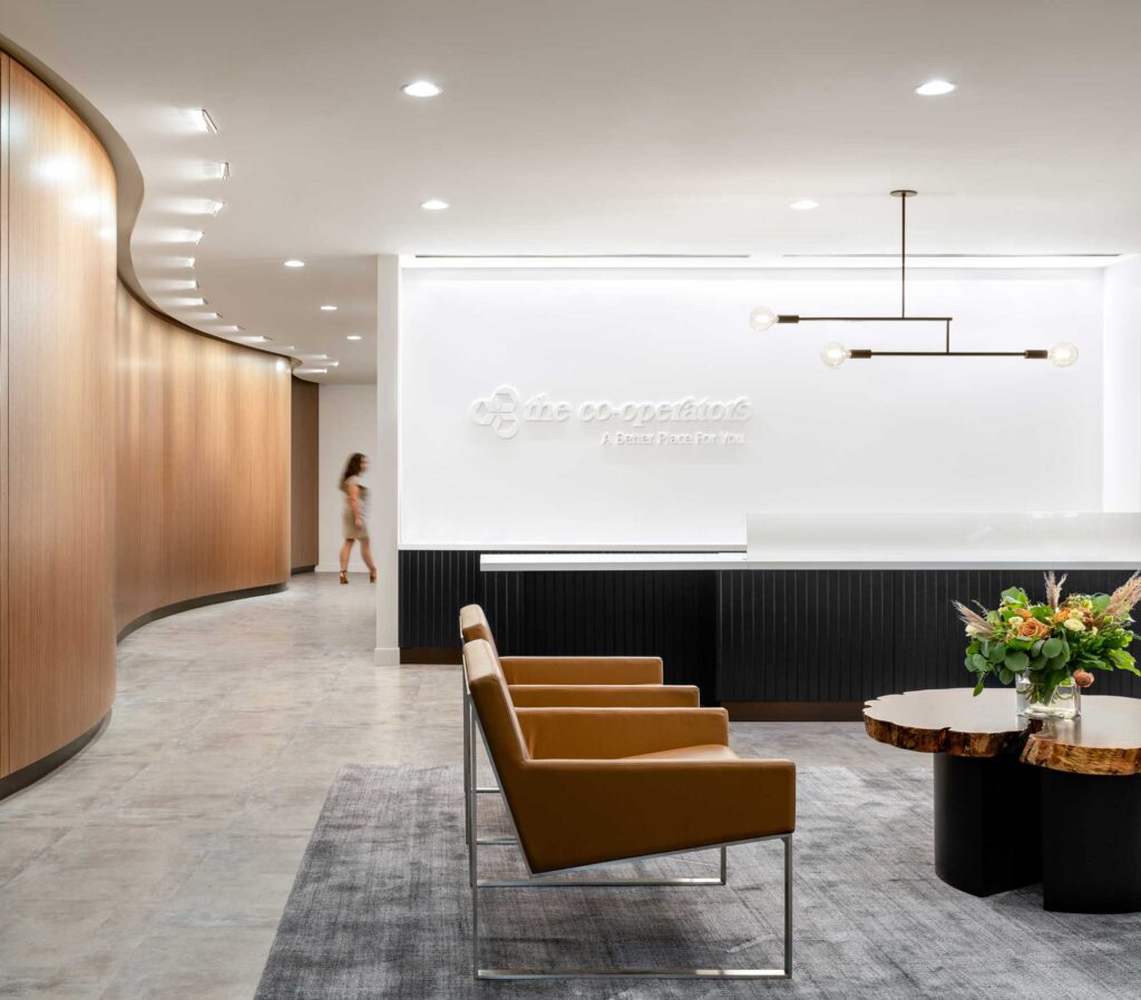 Reception area at the Cooperators Regina has a cool slate carpet and a curved wood wall lined across from the black-clad reception desk.