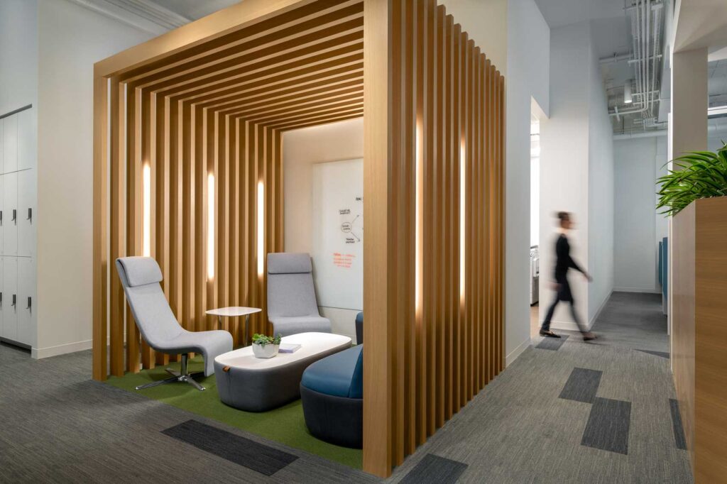A meeting area becomes a cozy nook with a slatted box overhead.