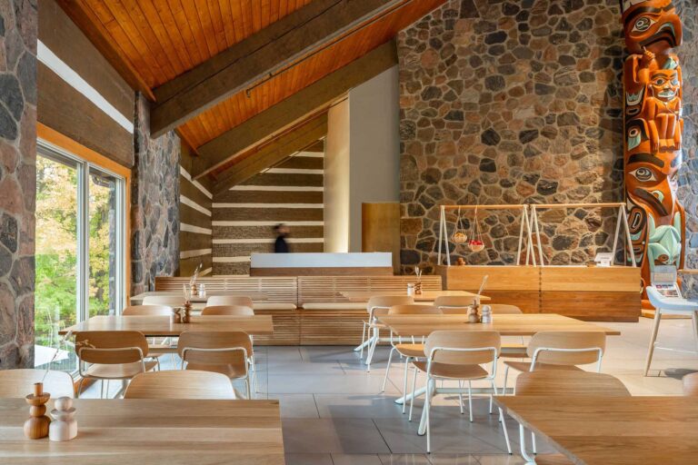 The cafe at the McMichael Canadian Art collection has several seating options with pale wood tables and white chairs.