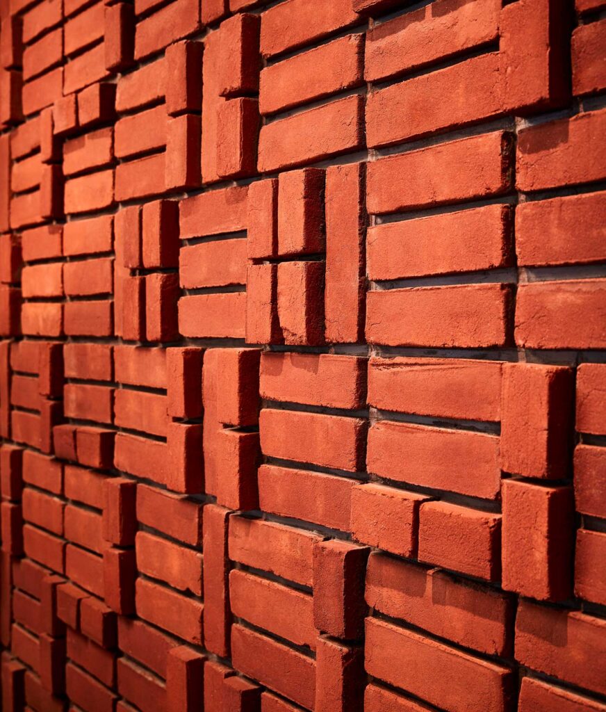 Raised bricks create a series of geometric patterns on a wall at Nando's Woodmore.