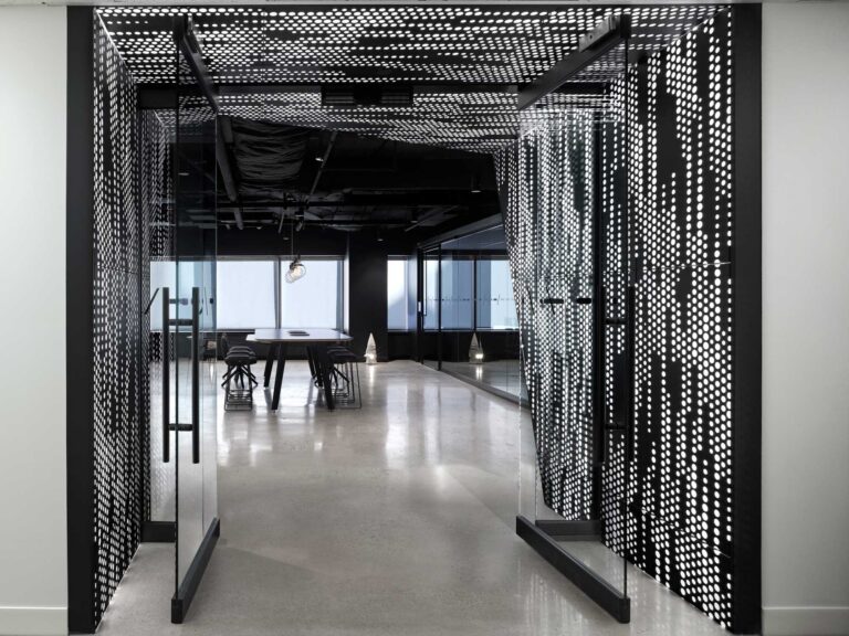 A perforated metal screen backlit in white sets the tone for stepping into the futuristic, phygital Smart City Sandbox.