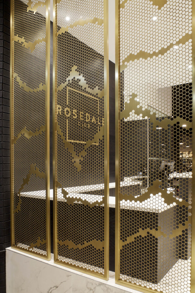 Golden tall mesh panels by the reception desk