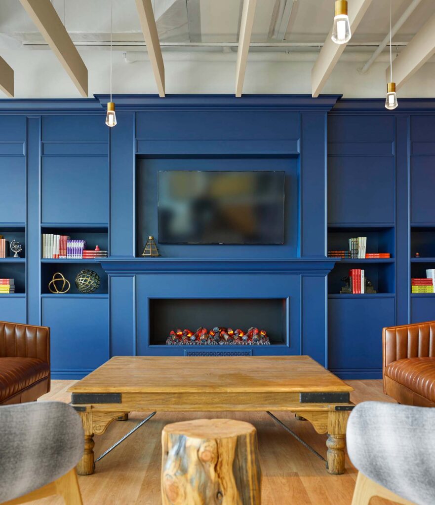 The pub area at the Text Now office is a twist on a classic pub with panelled walls done in a royal blue for an extra whimsical touch.