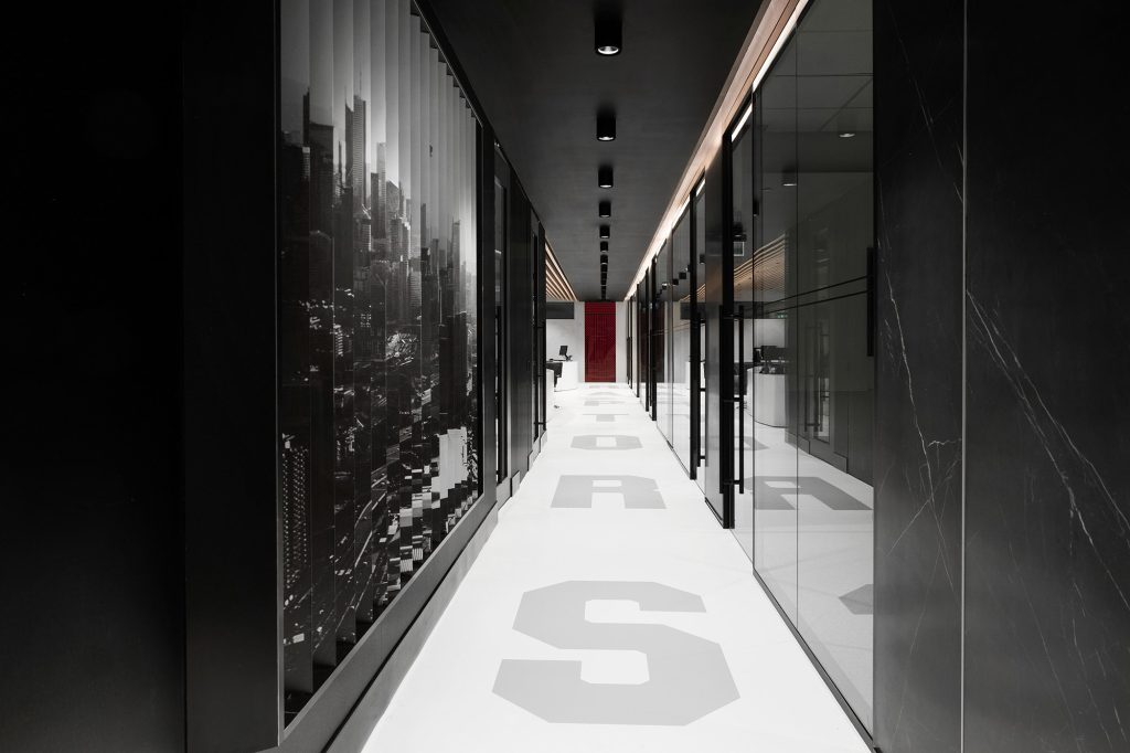 A large image of Toronto is displayed on an entire wall of the hallways leading to the offices and the word Raptors displayed on the hallway floor