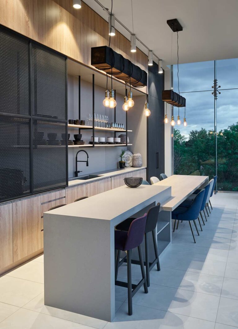 A modern industrial-style kitchen setting with wood finish cabinets and black mesh details. A long two-level, bar height and chair height concrete kitchen island extends along the entire length of the kitchen.