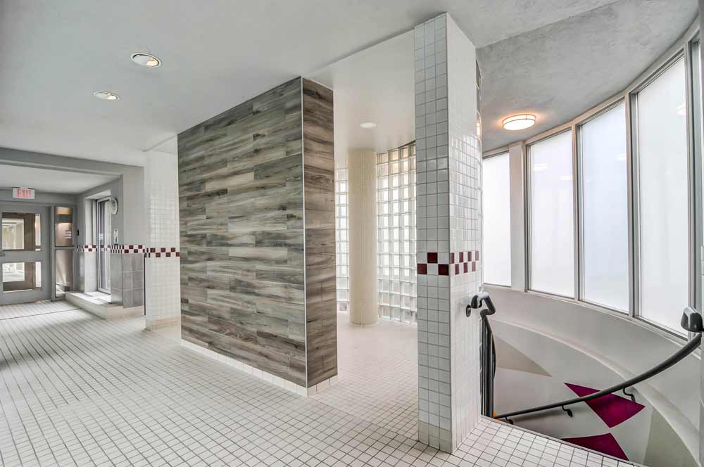 Another view of the shower wall as seen from the pool side showing the accessible entry to the large shower on both sides of the wall