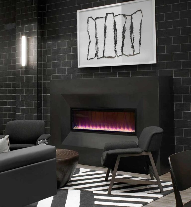 Lounge area vignette featuring a black brick wall with a black modern fireplace and large black and white artwork above it