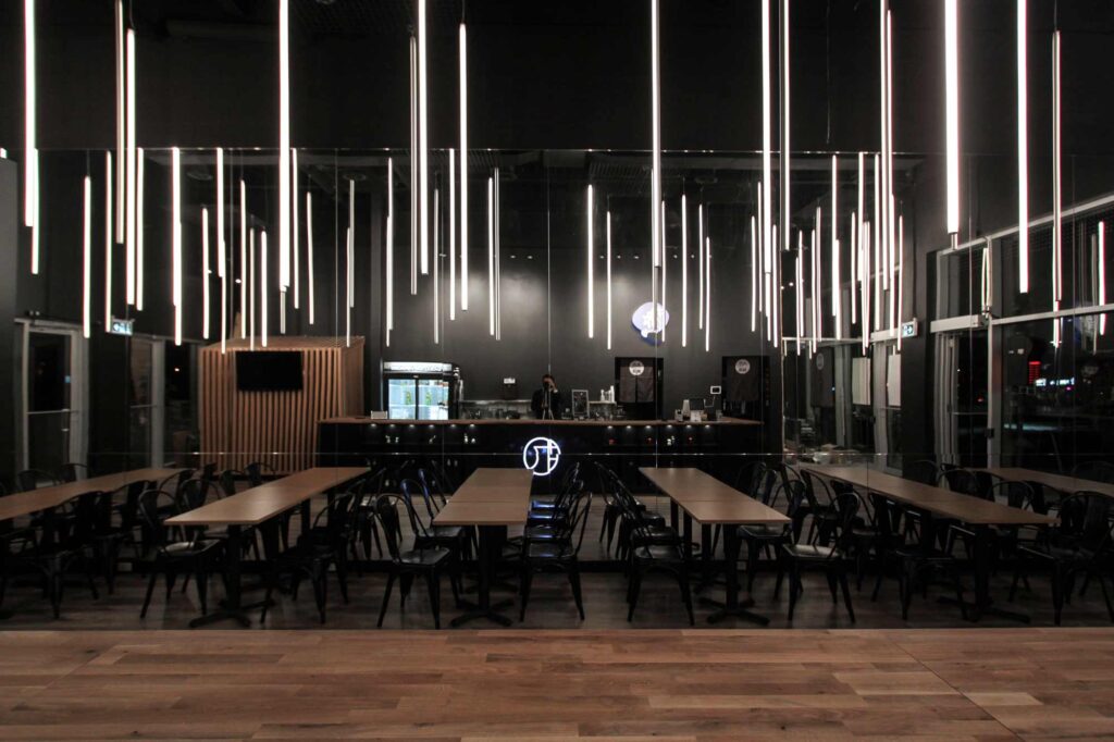 A view of the entire restaurant interior with the vertical LED lights hanging above