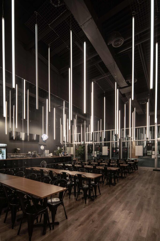 A view of the entire restaurant interior with the vertical LED lights hanging above