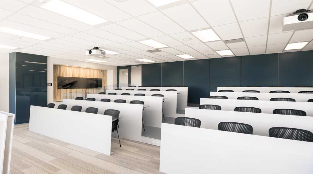 An auditorium style presentation hall in white, blue and beige colour scheme