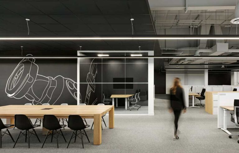 Open concept work station area in a black and neutral color scheme with open loft style ceilings