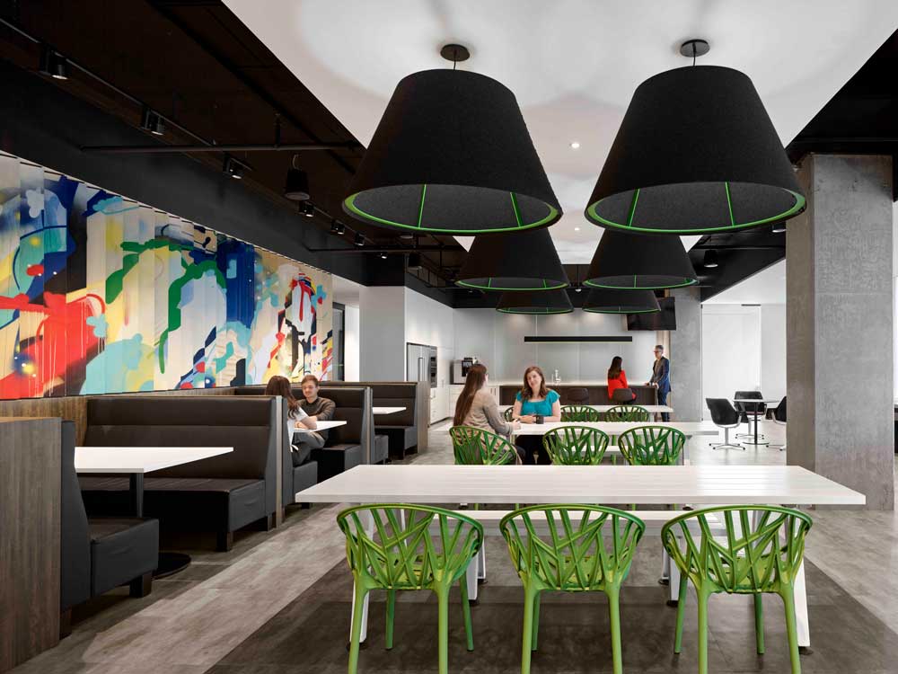 Cafe area with pops of green and a bespoke graffiti art on the wall to remind of Toronto's Graffiti alley