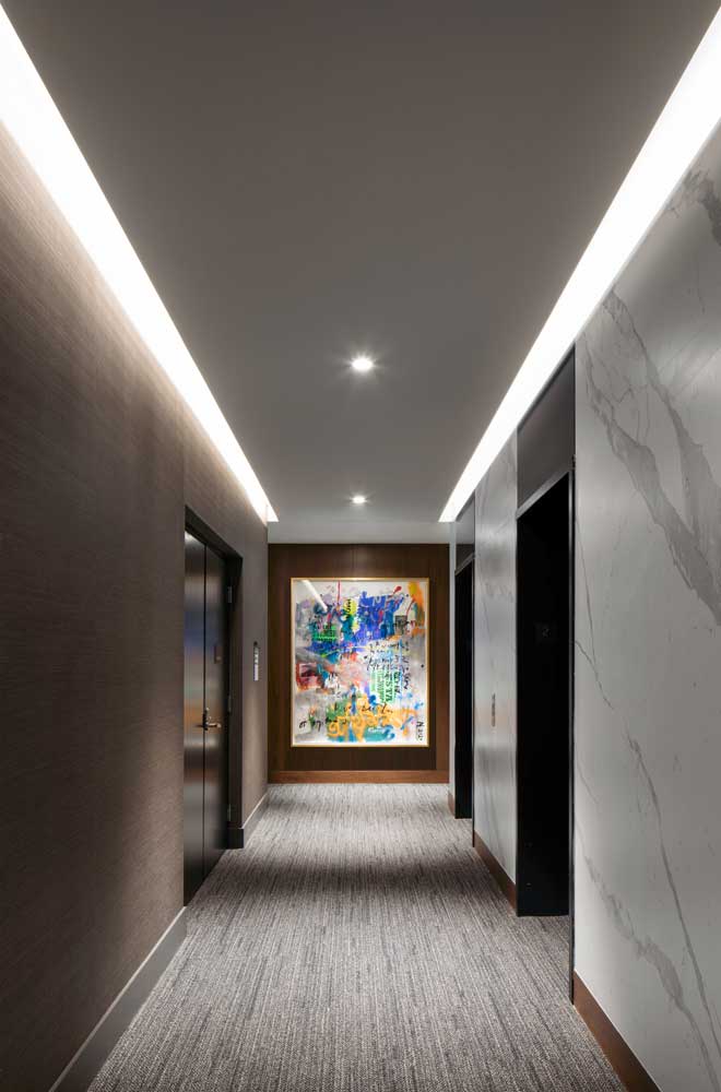 Elevator hallway in a neutral palette with a colourful artwork on the end wall