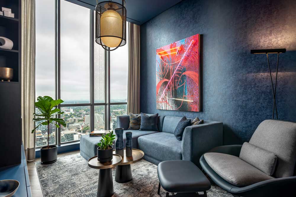 Dark and moody media room in predominantly dark blue colour with vibrant accents