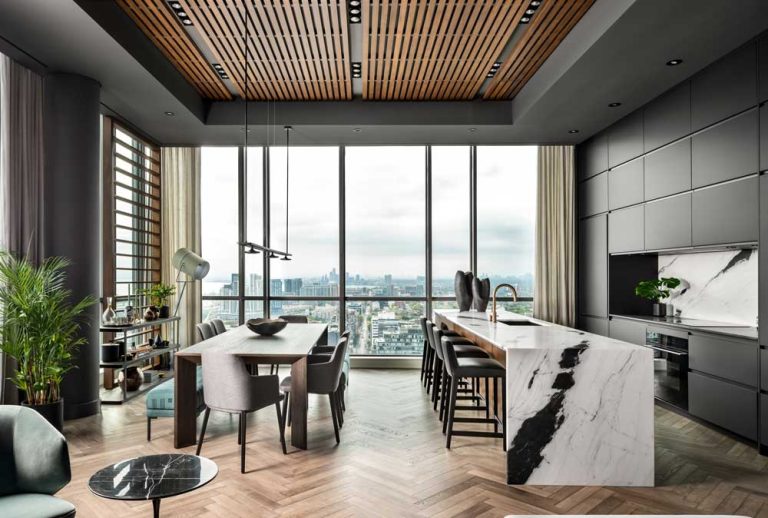 View of Toronto skyline through the large floor to ceiling window in the kitchen and dining room area