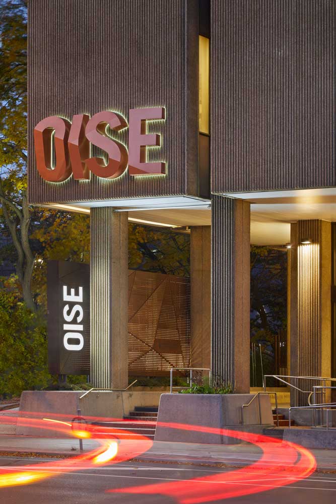 Night image illuminated dimensional OISE letter sign on the front of the building