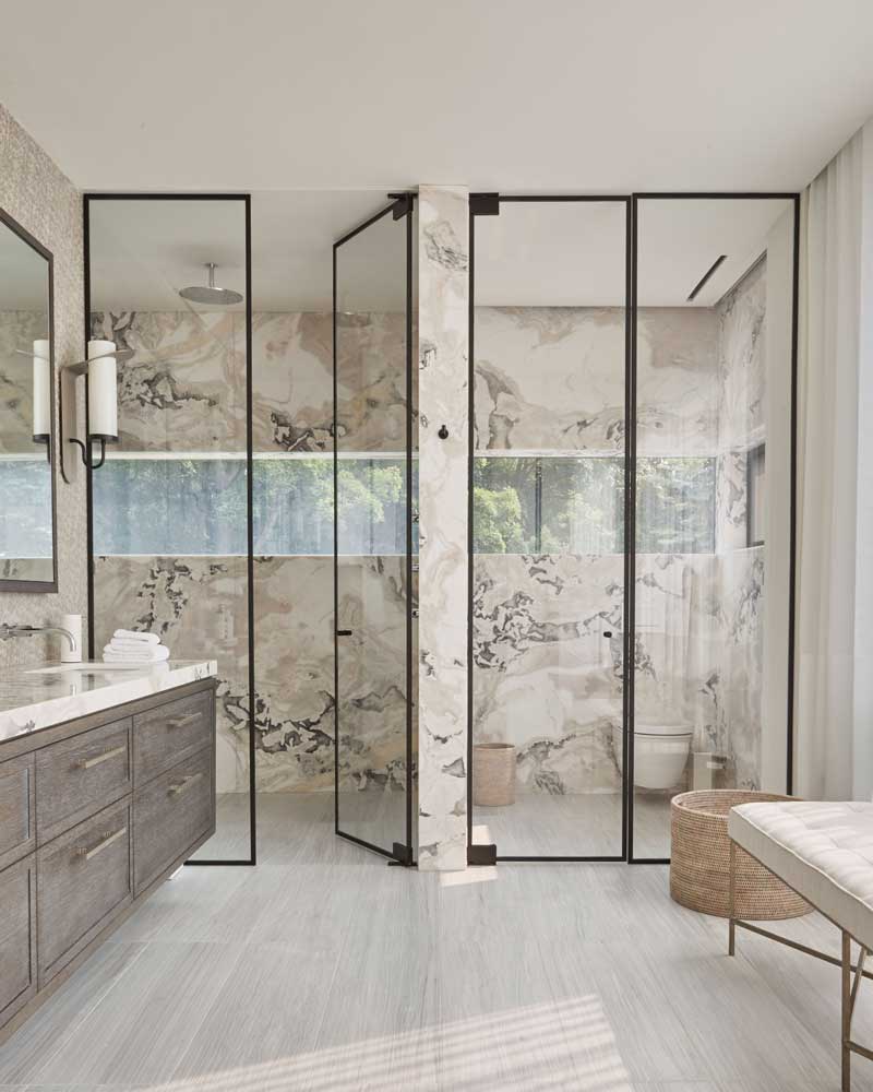 In the master bath we allowed the dramatic veining in the marble wall slabs to contribute to the colourful effect