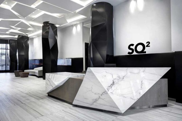 Geometric origami-like black columns, and ceiling details and the faceted security desk in the lobby