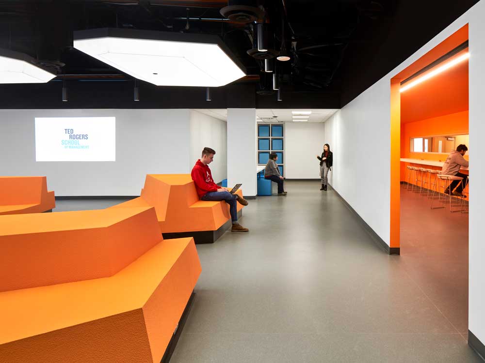 Another view of the main classroom, or lecture hall showing how the orange seating units can be used for lap top use as well