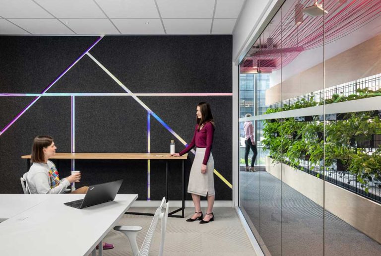 A conference room with a colourful geometric design on the feature wall