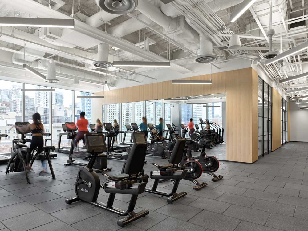Large open exercise space with views of the city through large windows