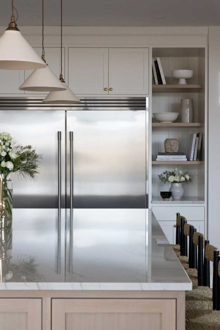 Shelving and Storage cabinets surrounding the huge double door stainless steel fridge