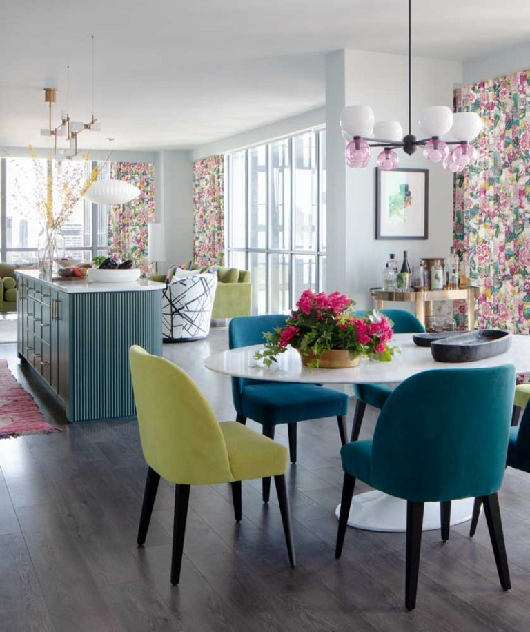 Colourful dining, kitchen and living area in bold colour combinations inspired by the lively pattern on the window drapery