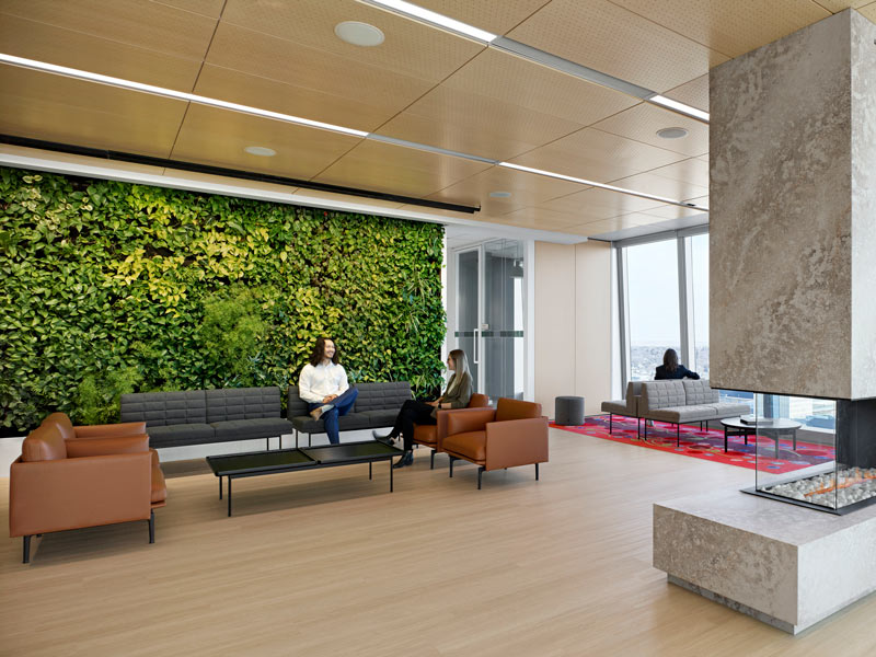 Waiting lounge with a huge biophilic wall and furniture in earthy tones