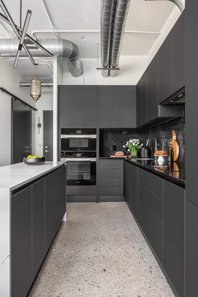 Black kitchen with flush doors, no hardware and industrial elements