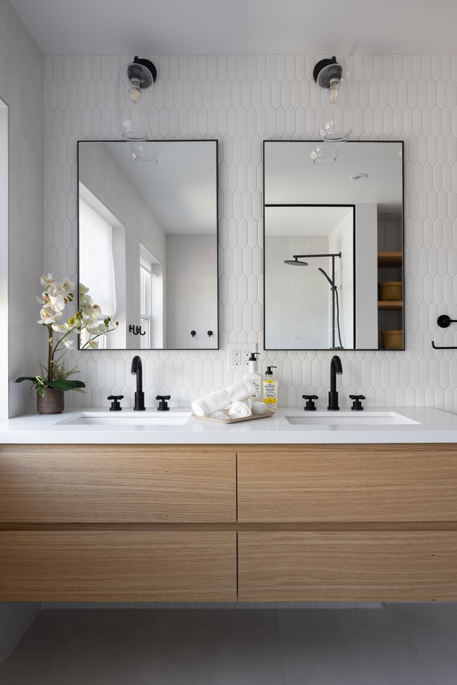 Ensuite bathroom vanity in wood finish with industrial style mirrors and lighting and hardware in black colour