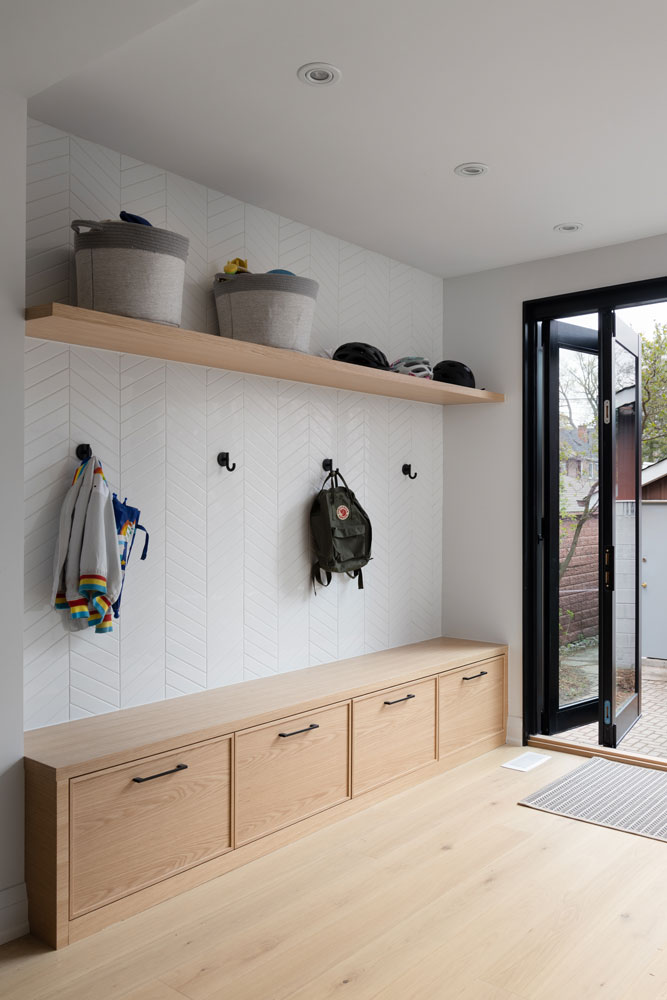 Clean and simple mudroom area by the exit to the back yard