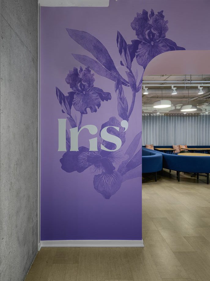 Iris' lounge - The entrance to one of the areas within the Shopify office. A purple wall with an image of Iris flower, purple on purple