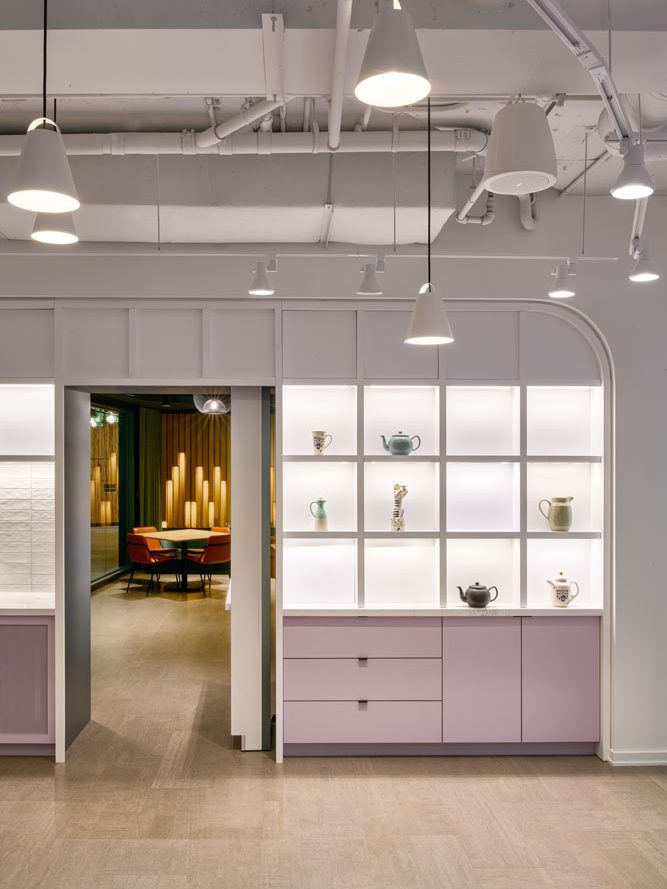 Built in shelves in white and dirty light pink colour next to the entrance to Karaoke lounge