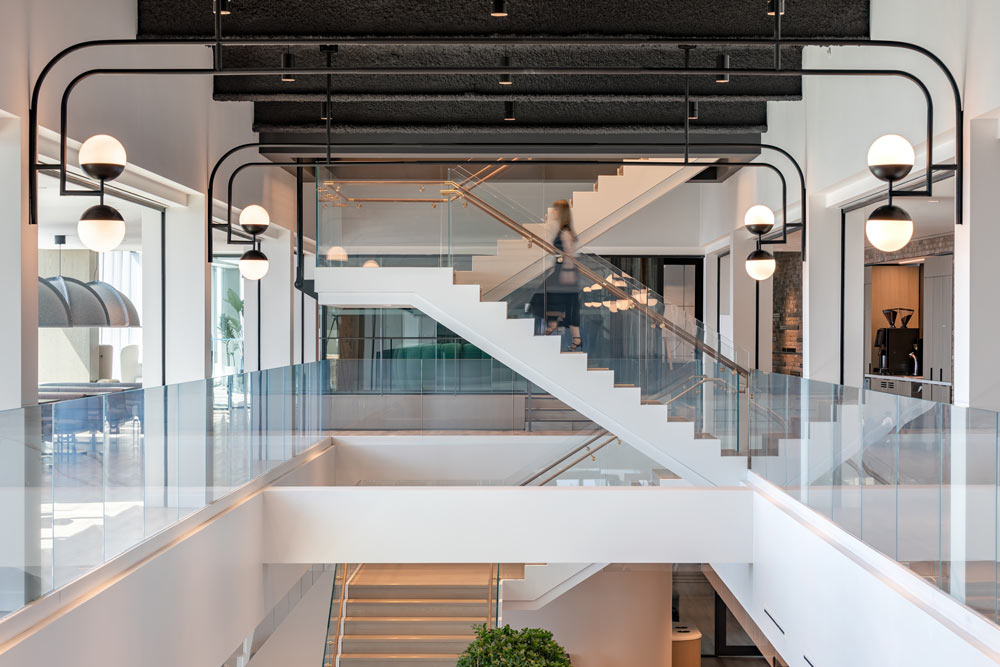 The interconnected stairway, featuring custom solid wood and brass detailing.