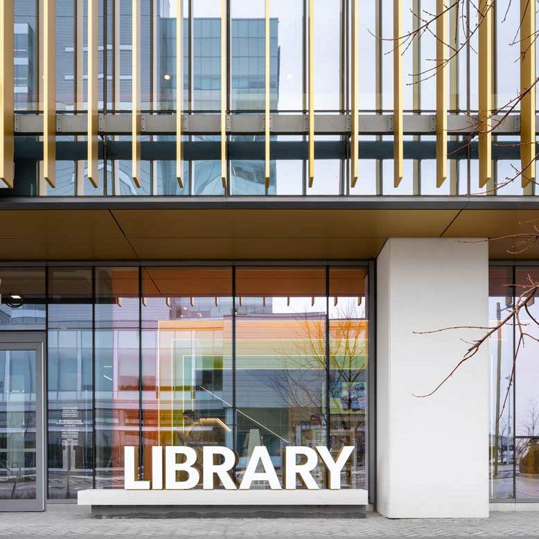 Store front with the colourful arches visible inside through the floor to ceiling windows