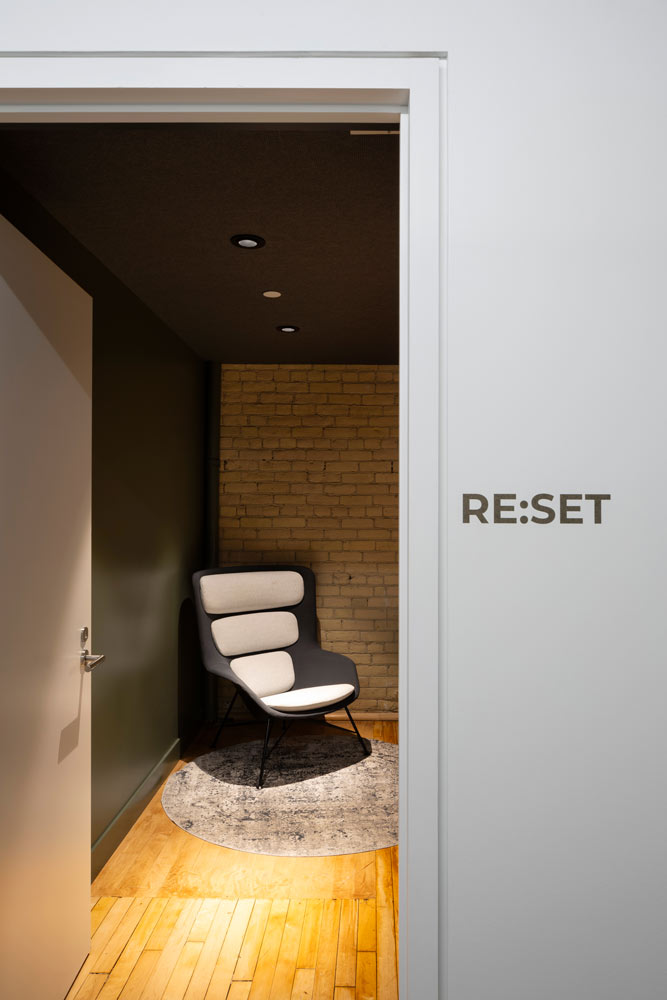 An entrance to the quiet multi-purpose room for prayer, meditation, wellness, and nursing. These is a single lounge chair sitting in the corner visible from the entrance door.