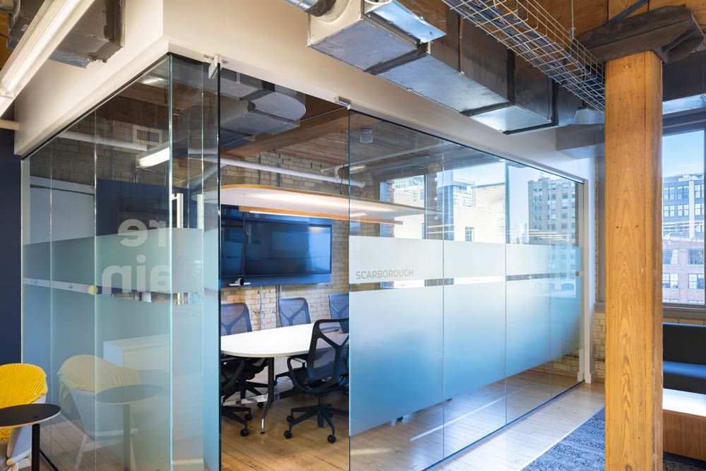 A private small meeting room enveloped with a glass wall.