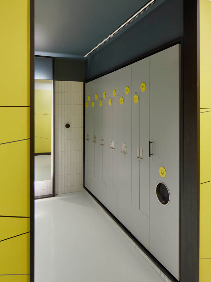 Lockers in the changeroom in gray colour with yellow circular number signs on each