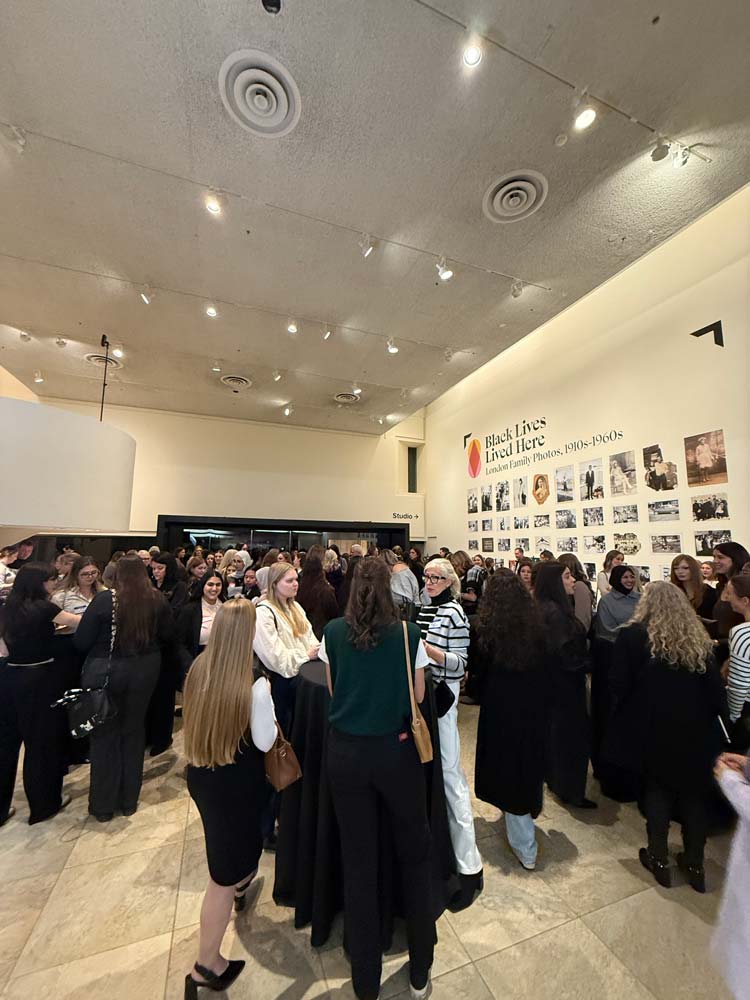 A crowd of people in the lobby area at the Fanshawe Interior Design + WAC Industry Night