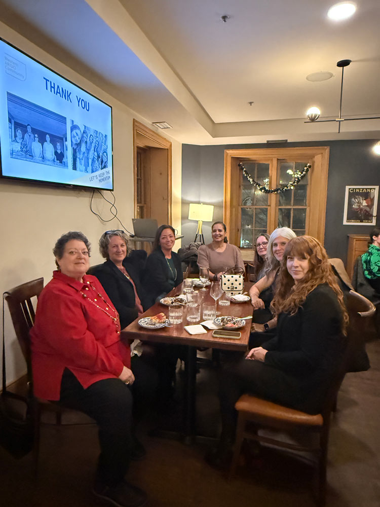 WAC members sitting at the table posing for a photo