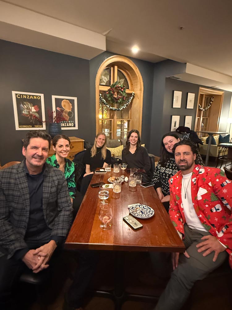 WAC members sitting at the table posing for a photo