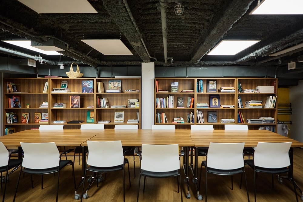 A library within a meeting room is available to encourage users to learn about Black artists and Black culture