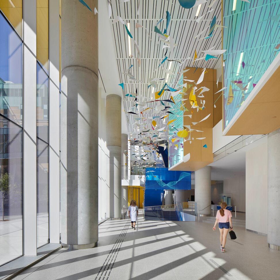 Mobils installation above the lobby space inspired by child's imagination, in bold coloured playful shapes